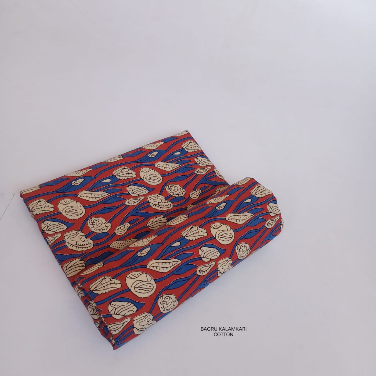 Bright red Bagru handblock printed cotton fabric with floral prints, artisan-made using eco-friendly natural dye techniques.